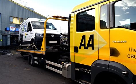 AA recovery lorry reversing into A1 Diagnostics Cardiff with a white van being unloaded. AA recovery lorry reversing into A1 Diagnostics Cardiff with a white van being unloaded.