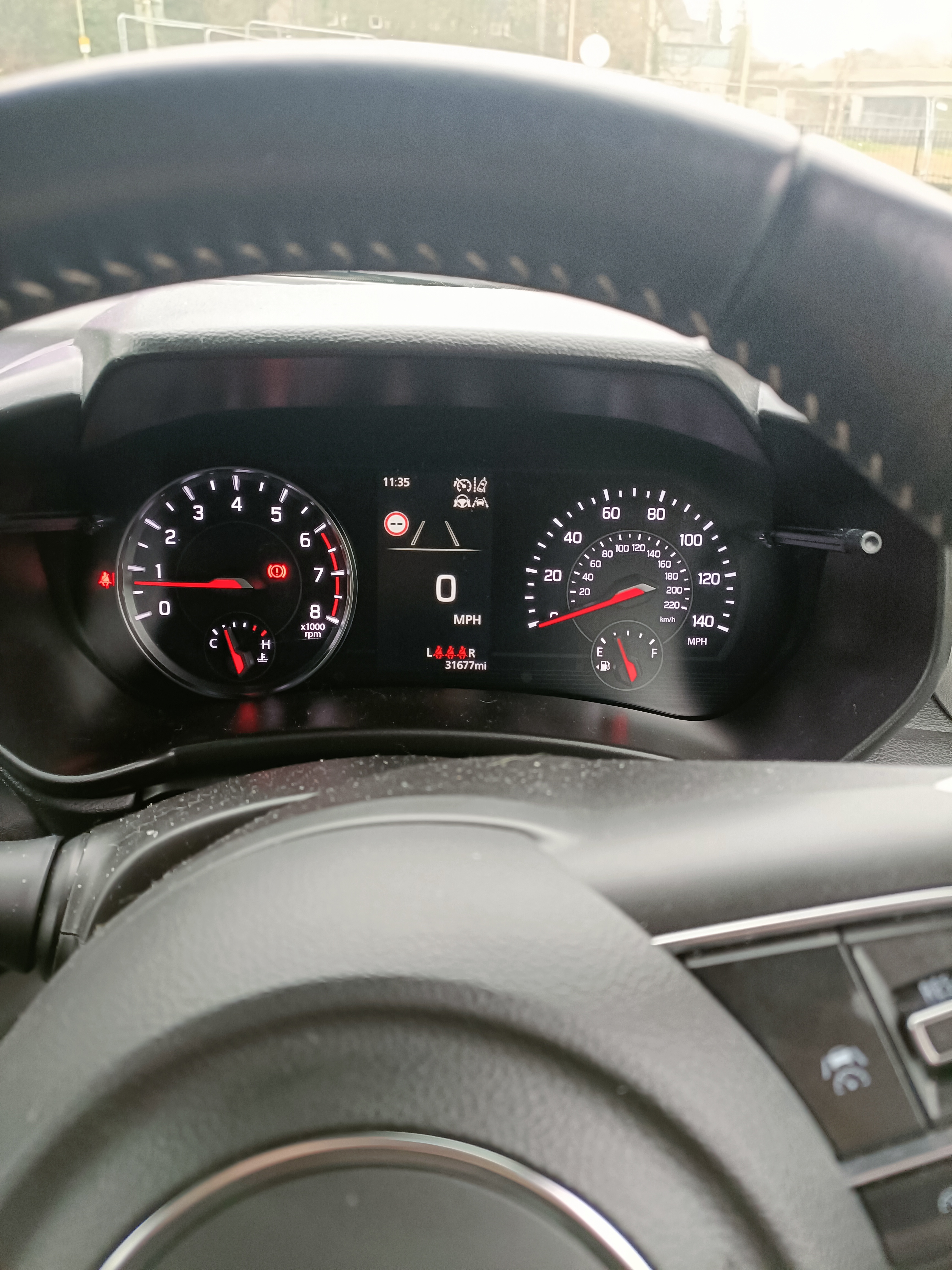 View from the driver’s seat looking through the steering wheel at the dashboard controls View from the driver’s seat looking through the steering wheel at the dashboard controls