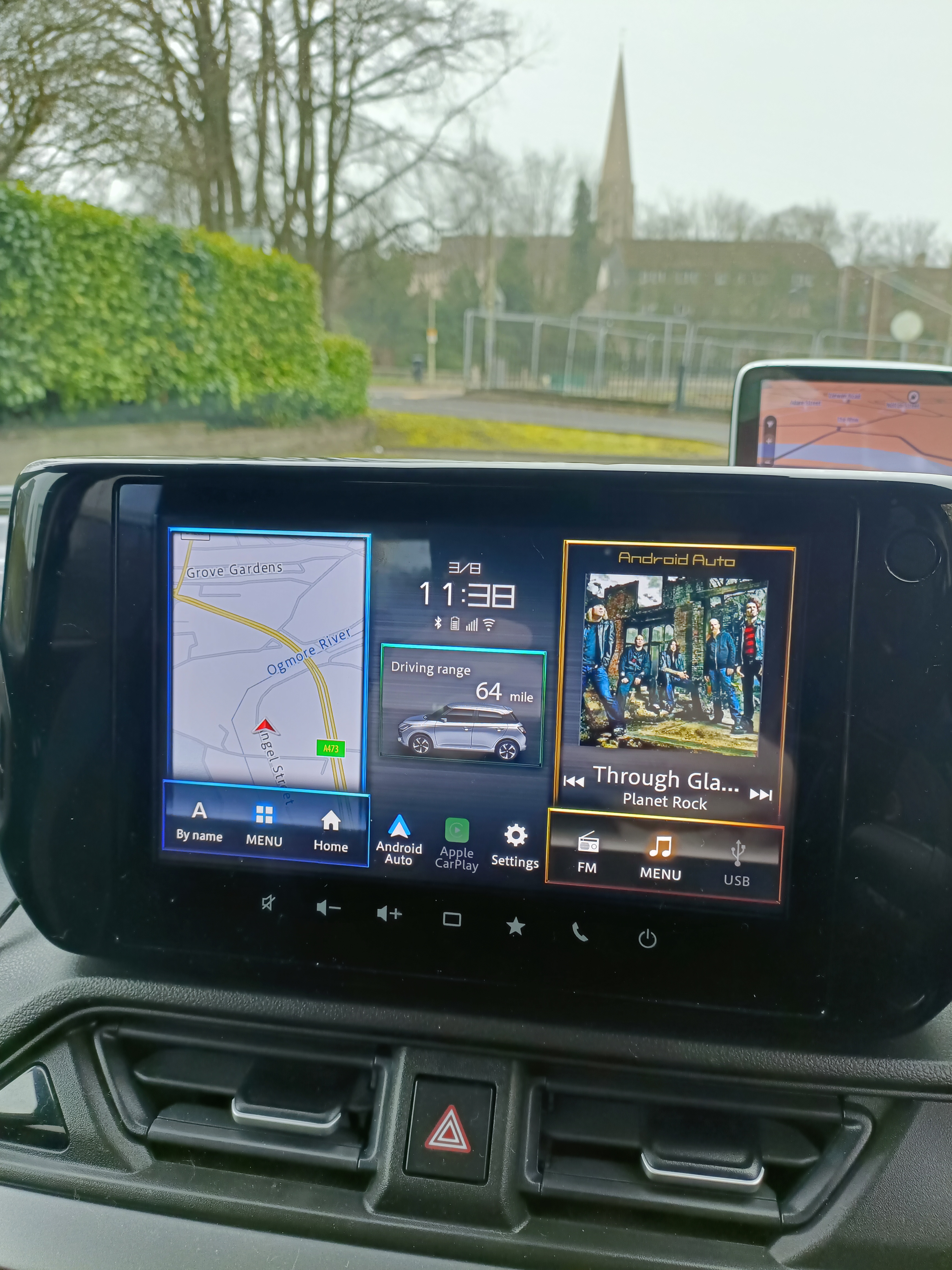Car’s central touchscreen showing map view, vehicle settings, fuel level and media information Car’s central touchscreen showing map view, vehicle settings, fuel level and media information