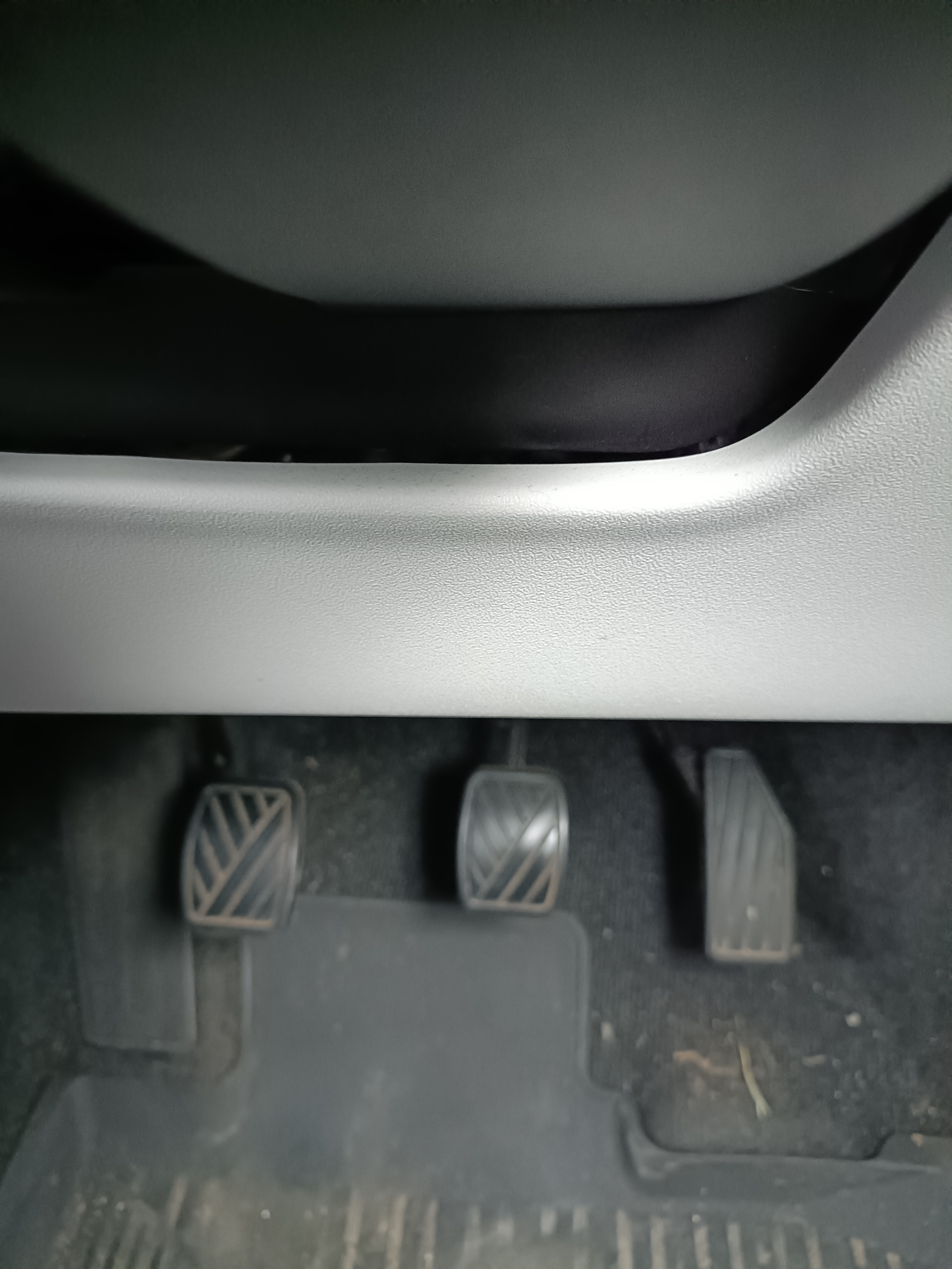 View looking down at the car’s foot pedals for clutch, brake and accelerator View looking down at the car’s foot pedals for clutch, brake and accelerator