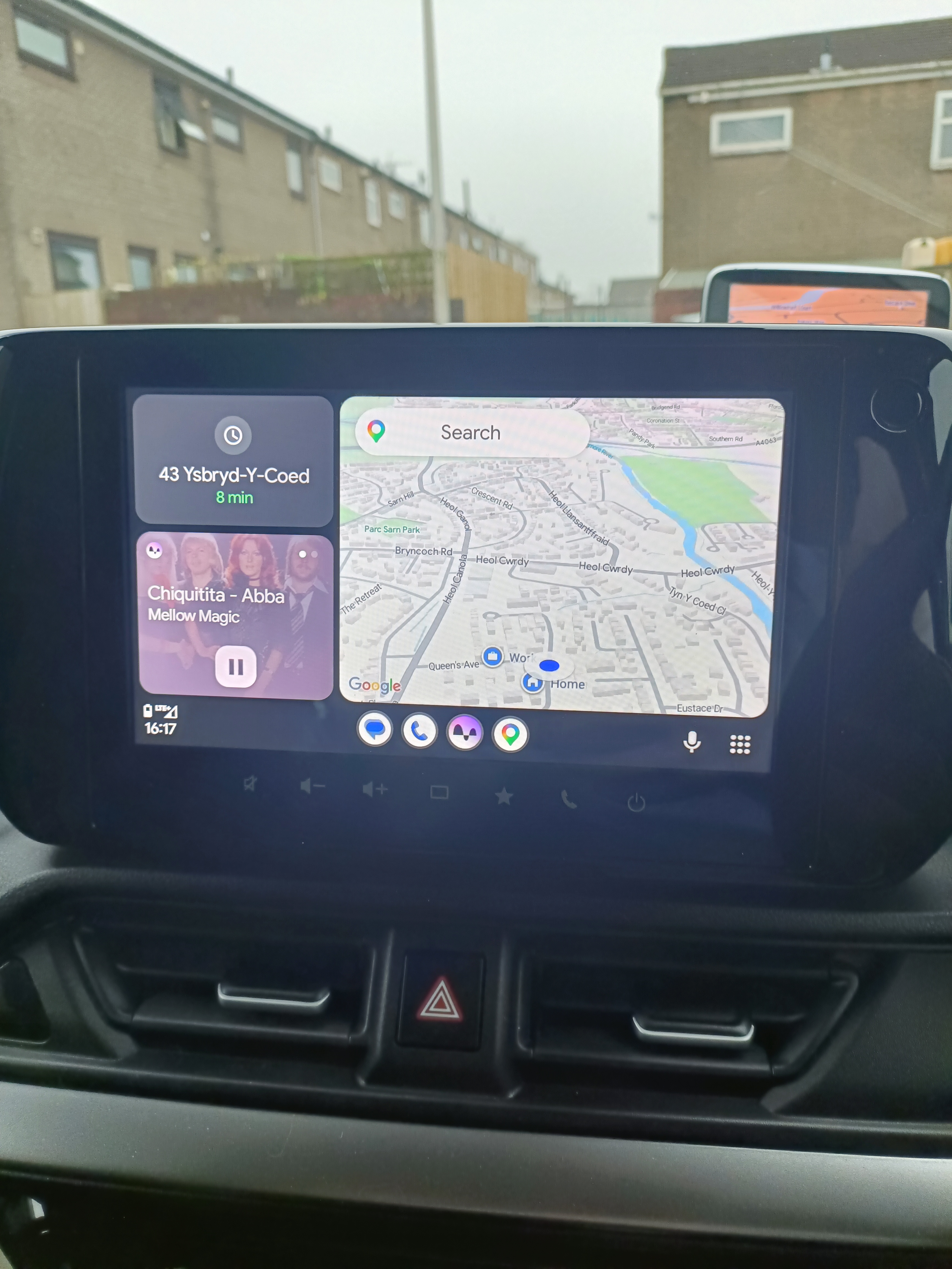 Car’s central touchscreen displaying Android Auto with Google Maps showing the car’s location and music currently playing” Car’s central touchscreen displaying Android Auto with Google Maps showing the car’s location and music currently playing”