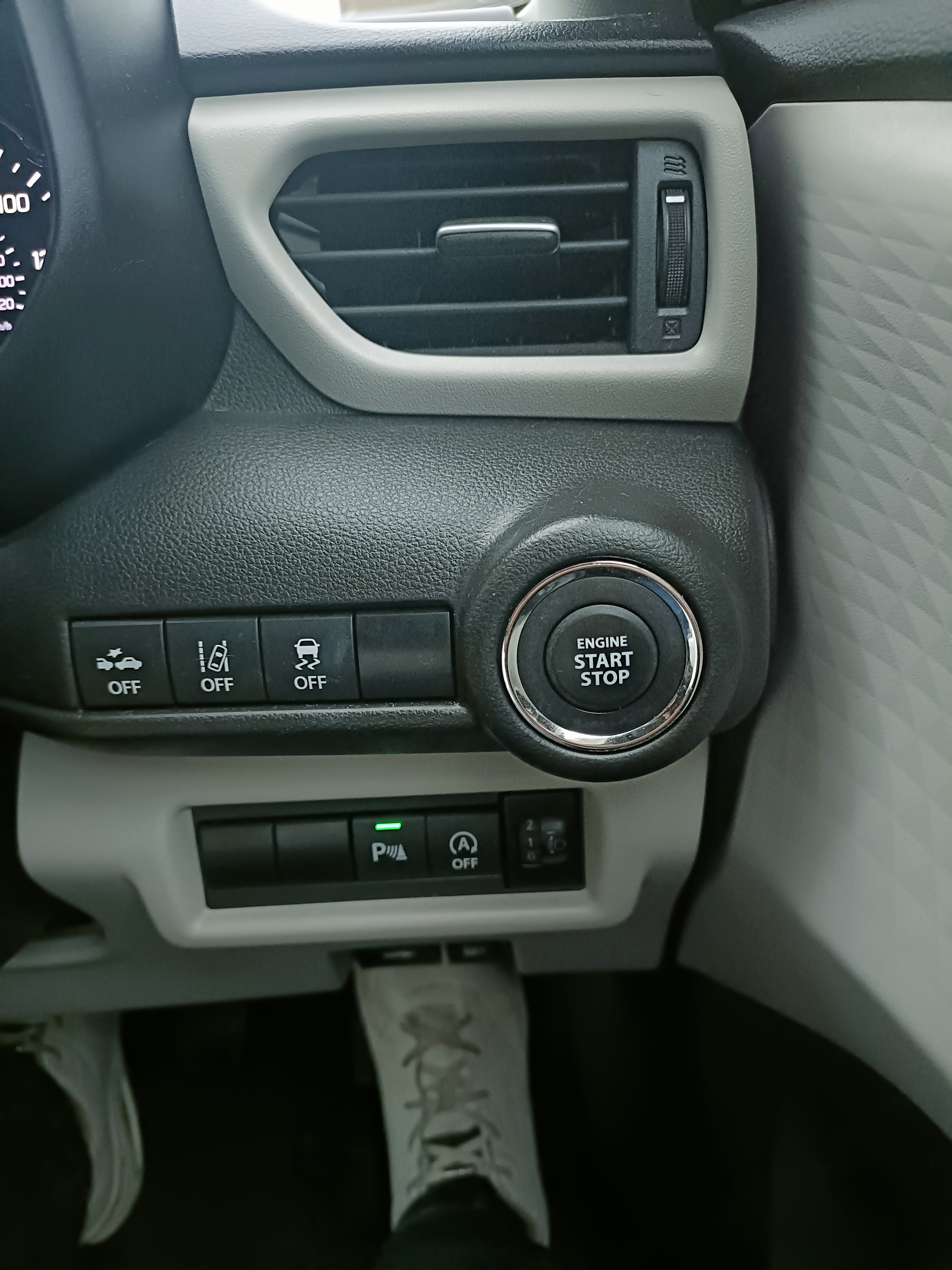 Car’s start button and electronic steering assistance controls on the dashboard Car’s start button and electronic steering assistance controls on the dashboard