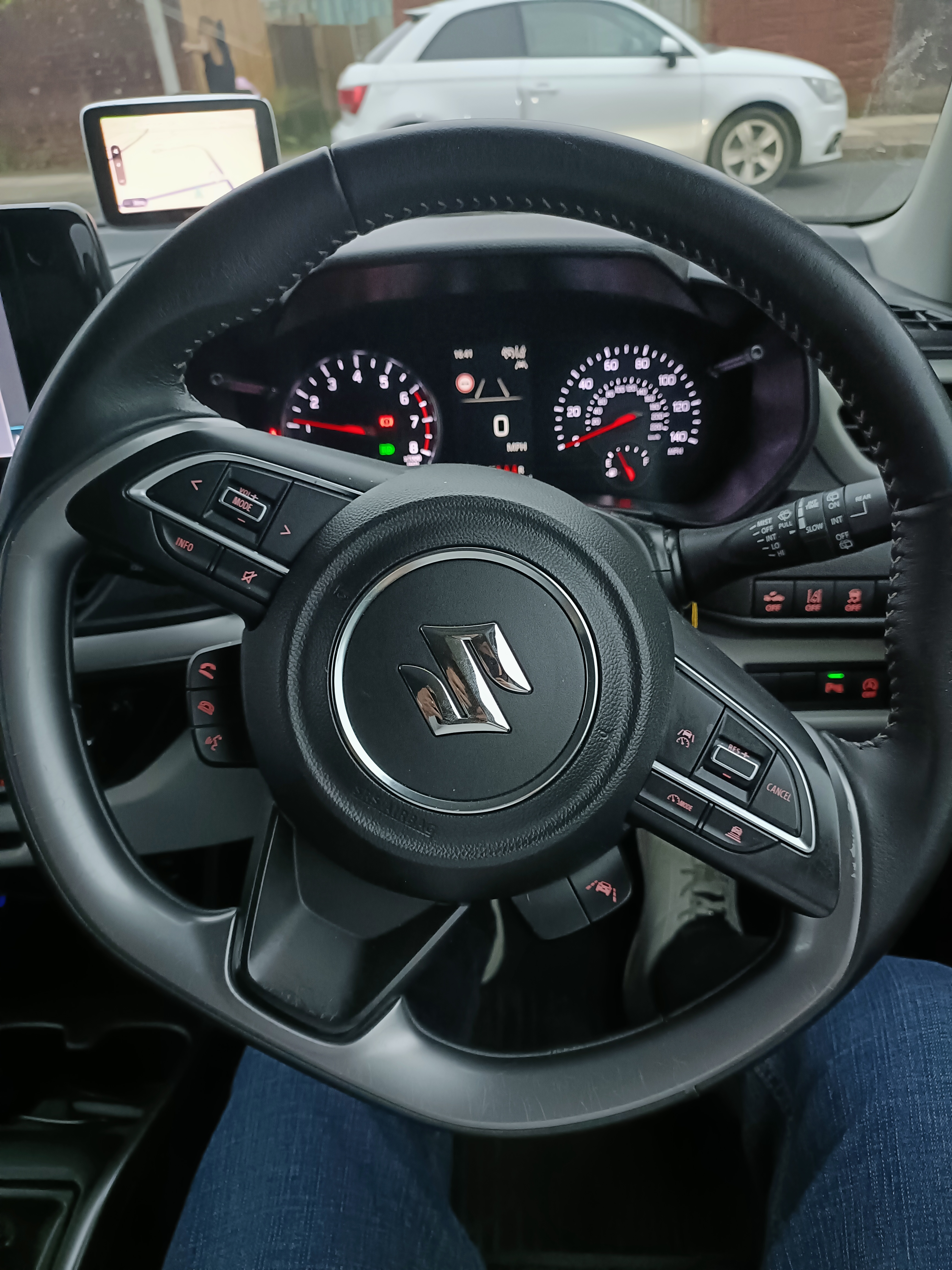 Instrument panel viewed through the steering wheel showing dashboard display and steering wheel controls Instrument panel viewed through the steering wheel showing dashboard display and steering wheel controls